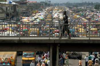 Akintunde_Akinleye_001-350x230 Man walks on pedestrian bridge in Lagos Nigeria 